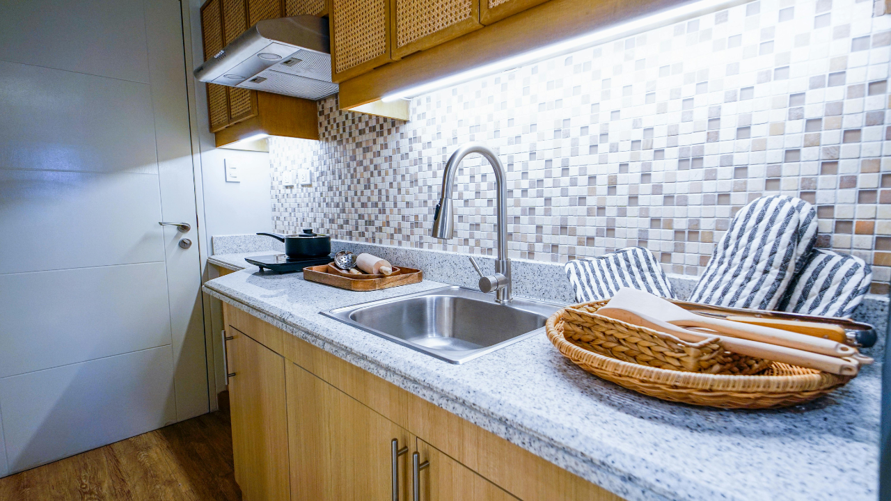 Wooden cabinetry kitchen with stone backsplash and quartz countertop